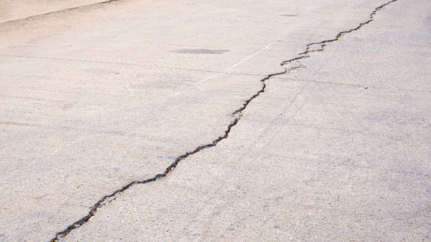 istock Damaged concrete street background with long crack line texture on surface 2205386028