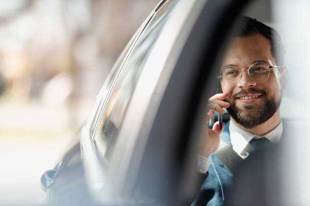 istock Businessman Talking on Phone Inside Car 2205387584
