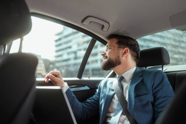 istock Businessman Working on Laptop in Car 2205387596