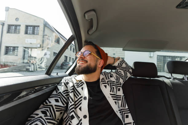 istock Cheerful Man Relaxing in Car Backseat 2205387599