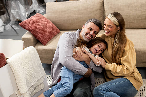 istock Parents and their little girl playing while moving in 2205388713