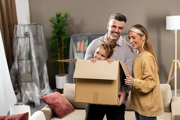 istock Couple having fun with their cute girl while moving in 2205388722