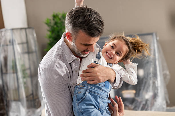 istock Dad and his cute girl playing while moving in 2205388734