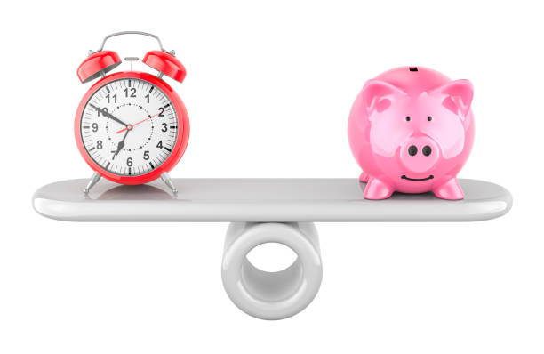 istock Piggy bank and alarm clock on balance scale. 3D rendering 2205388925