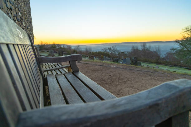 Early morning sunrise sky local church wooden bench Surrey England Europe