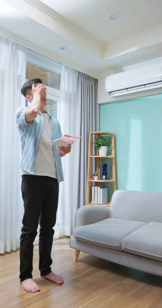 istock Asia man unhappy waste electricity 2205391673