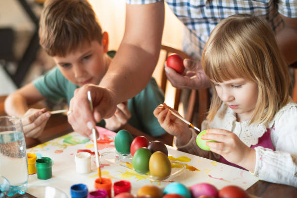 istock Family painting Easter eggs 2205392595