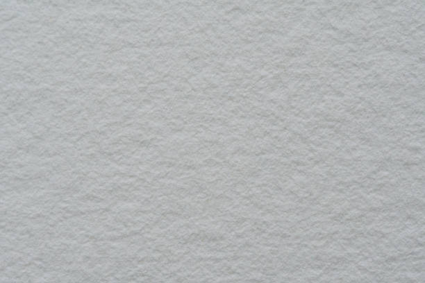 A top-down view of 100% cotton handmade Fabriano paper, showcasing its organic texture against a clean white background. The raw, unbleached fibers create a natural aesthetic, perfect for eco-conscious branding and stationery design.