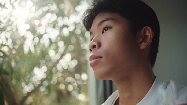 Teenager looking through the window.