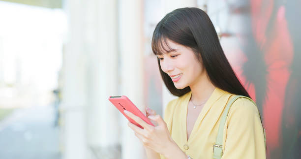 istock Asian female using mobile phone 2205392725