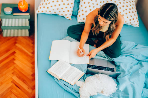 istock Young woman studying comfortably at home 2205393205