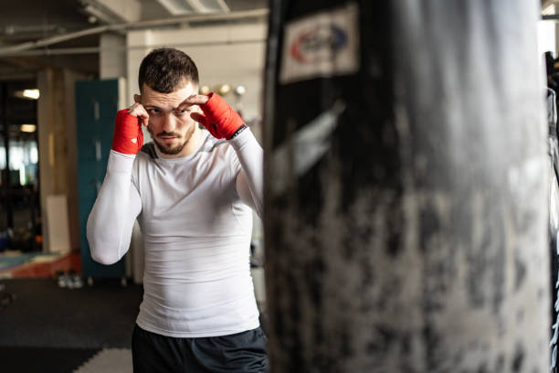istock Focused Athlete Training with a Punching Bag in a Modern Gym 2205397960