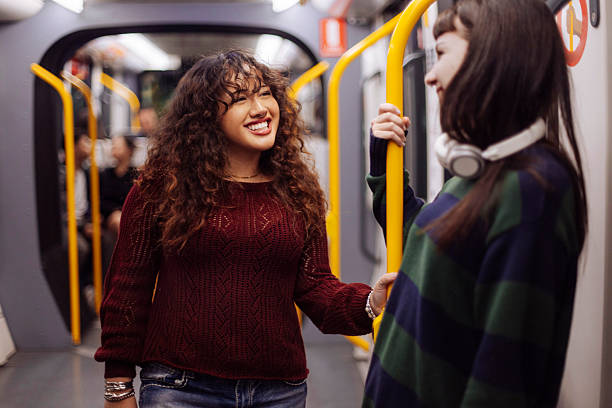 istock Girls chatting in public transportation 2205398549