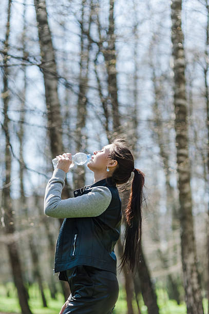 istock Woman with a long tail drinking water in a green forest 2205398865