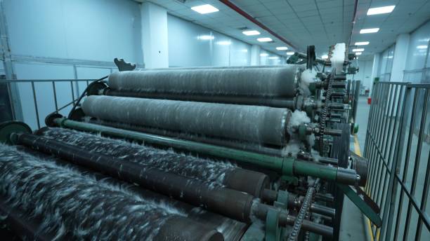 istock Carding machines in a woolen sweater factory 2205398880