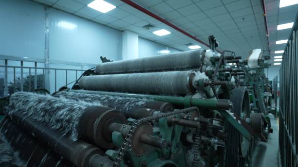 istock Carding machines in a woolen sweater factory 2205398890