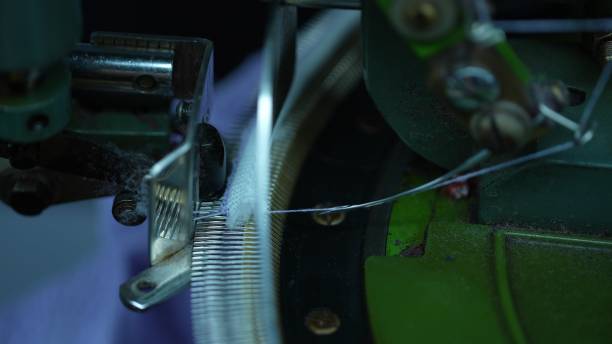 istock Overlock machines in a woolen sweater factory 2205399599