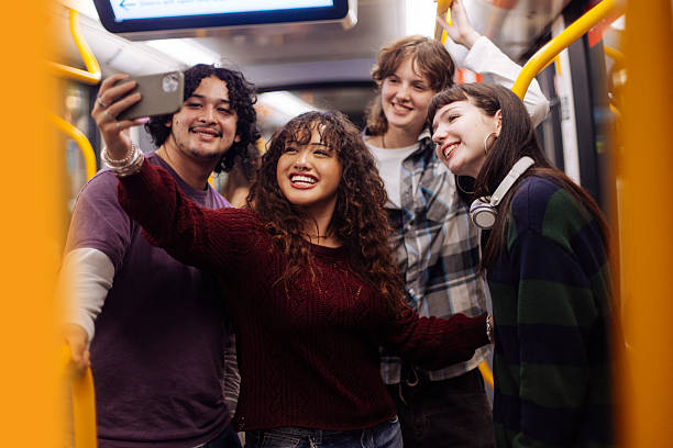 istock Diverse teenagers taking selfies in subway train 2205400189