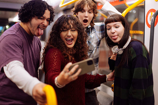 istock Goofy friends taking selfies in subway train 2205401000