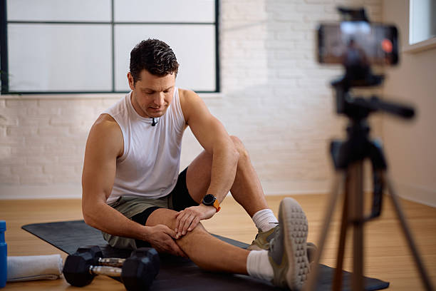 istock Personal coach live streaming from his fitness studio. 2205402343