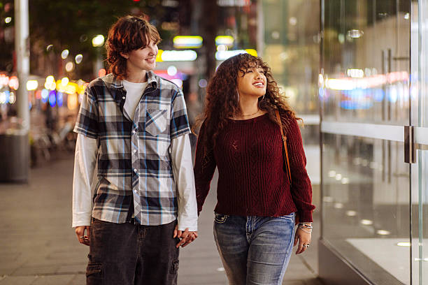 istock Young couple walking on a street 2205402460