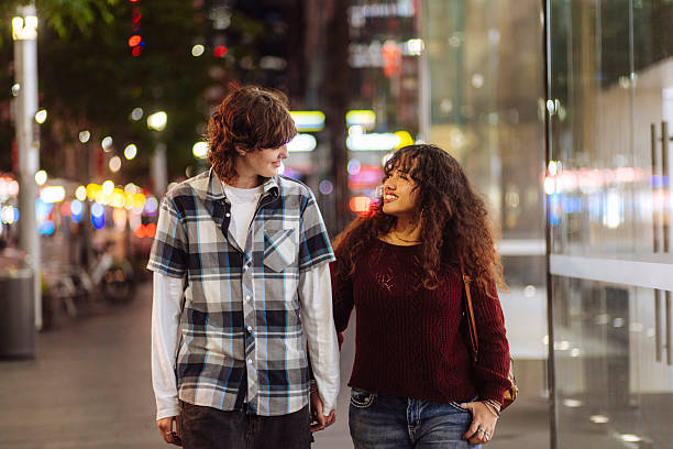 istock Diverse gen z couple walking on a street 2205402463