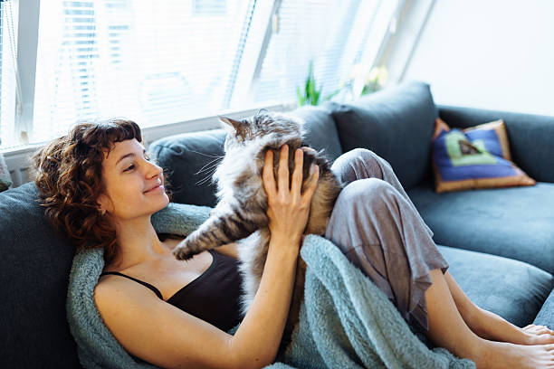 istock young woman hugging a gray fluffy cat 2205403155