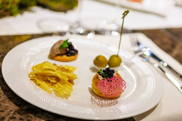 istock Elegant gourmet appetizers served on white porcelain. 2205405089
