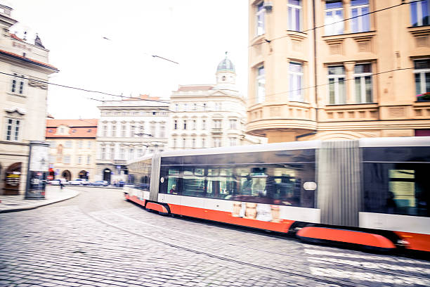 Prague, Czech Republic - June, 12, 2024:  Modern tram leads through the old town of Prague. Panning photo.