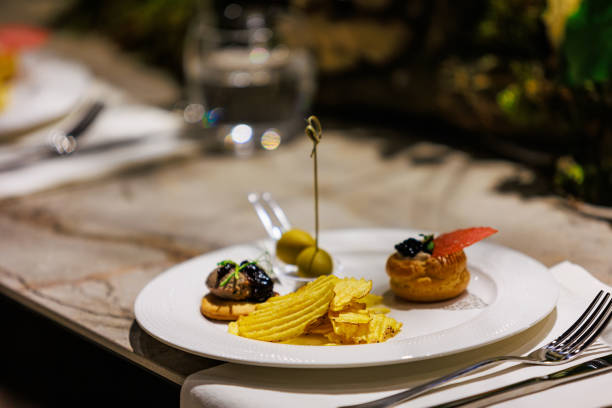 istock Elegant gourmet appetizers served on white porcelain. 2205405128