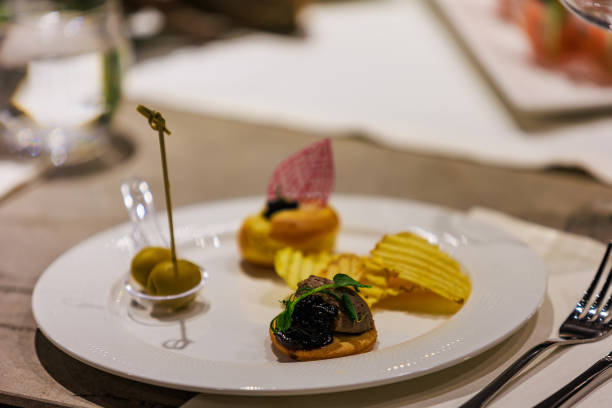istock Elegant gourmet appetizers served on white porcelain. 2205405129