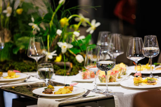 istock Luxurious dining table setup featuring gourmet appetizers, elegant glassware, floral centerpiece 2205405132