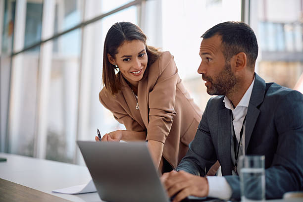 istock Business colleagues cooperating while working on laptop in the office. 2205405477