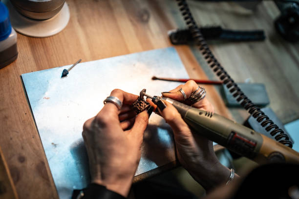 istock Close-Up of Artisan Working on Jewelry Using a Rotative Tool 2205407310