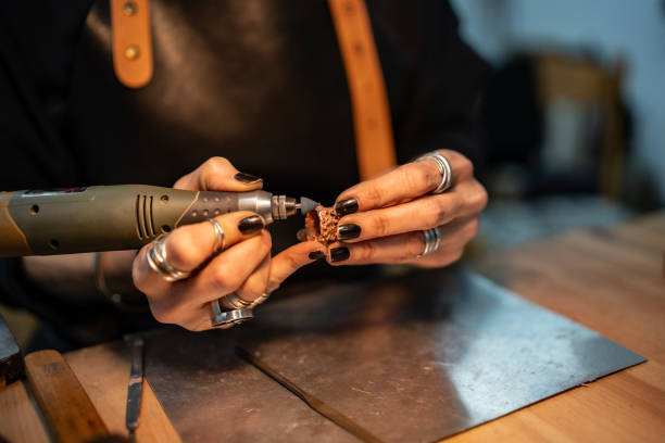 istock Artisan Handcrafting Jewelry With Rotary Tool in Workshop 2205407380