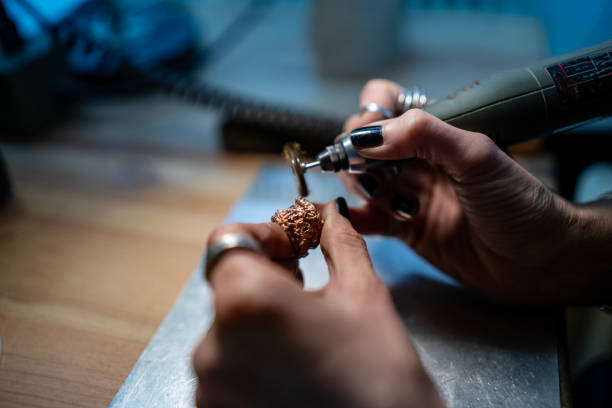 istock Close-Up of Hands Crafting Jewelry Using a Rotary Tool in a Workshop 2205407416