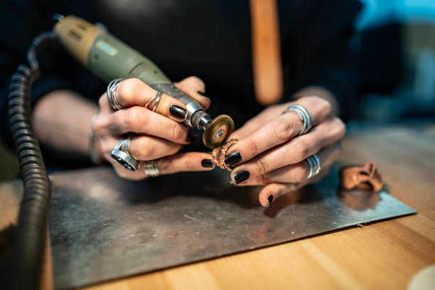 istock Close-Up of Skilled Artisan Using Rotary Tool for Delicate Metalwork 2205407420