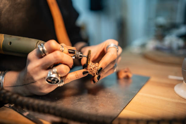 istock Close-Up of Hands Crafting Jewelry Using a Rotary Tool 2205407426