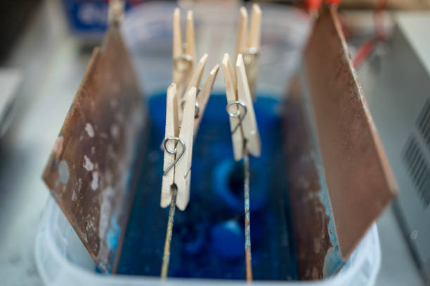 Close-up view of an electroplating setup demonstrating chemical processes and scientific experimentation.