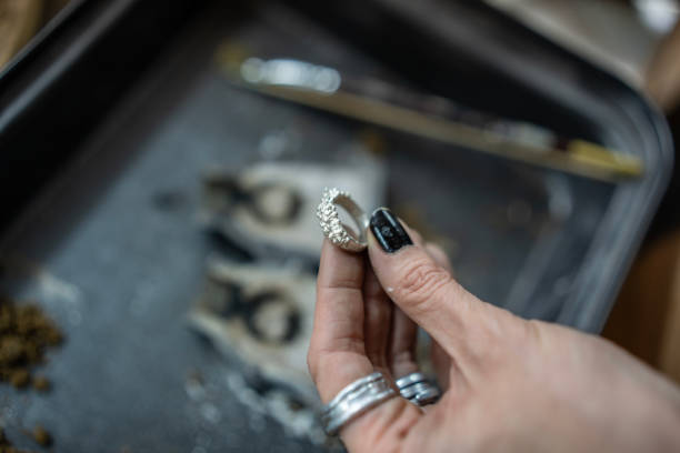 istock Hand Holding Ornate Ring Design in Craft Jewelry Workshop Setting 2205408307