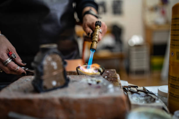 istock Craftsman Working with Blowtorch in Workshop on a Metal Creation 2205408569