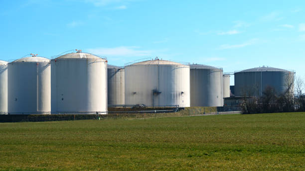 istock Multiple large storage silos standing in an open field under a clear blue sky 2205410231