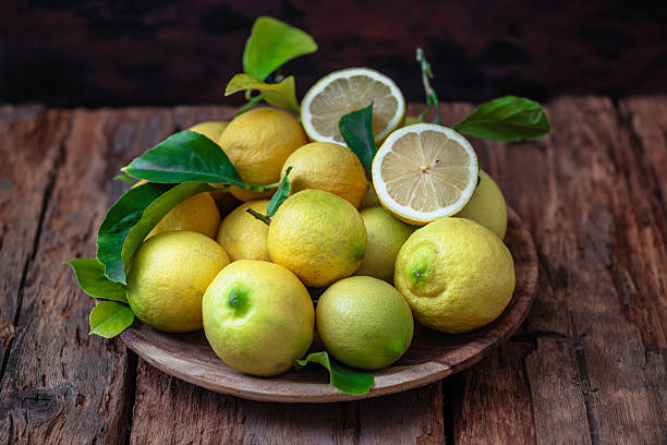 istock Fresh ripe lemons with green leaves 2205411254