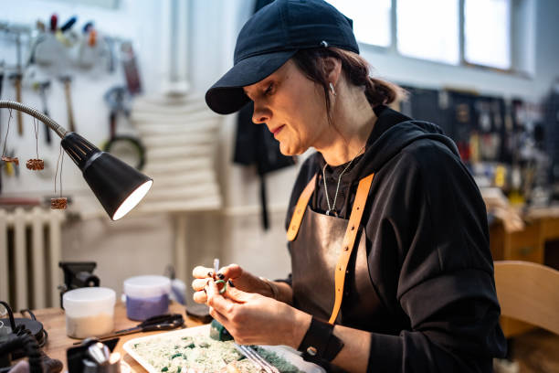 Focused Craftsperson at Work Creating Handcrafted Jewelry in a Diverse Workshop Setting