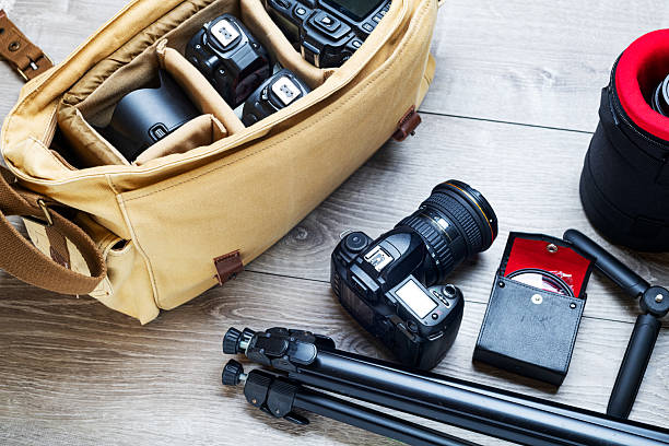 Professional photography equipment and a canvas bag on a gray table. View from above.