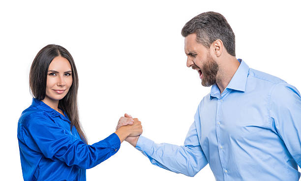 istock confrontation in office. business competitors doing arm wrestling. competition for leadership. business competition. two businesspeople competing in arm wrestling. conflict between colleague 2205415237