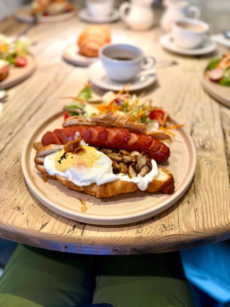 istock Croissant sandwich with sausage and poached egg served at breakfast 2205415834