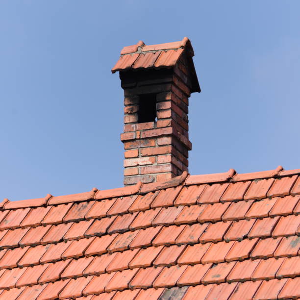 istock Vintage look brick wall chimney and roof. 2205417843