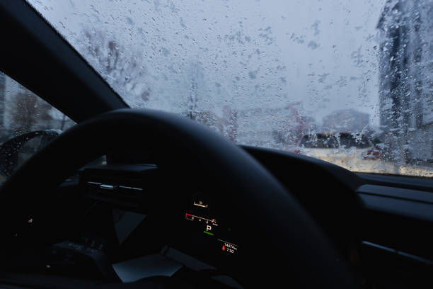 istock On a winter morning drive to work before the dawn breaks, sitting inside the car , accompanied by the silent snowfall, stock photo 2205419533