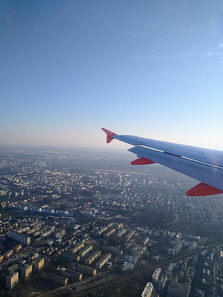 Krakow, Malopolskie, Poland - 02/20/2025: easyjet wing over Krakow city | view from passenger perspective